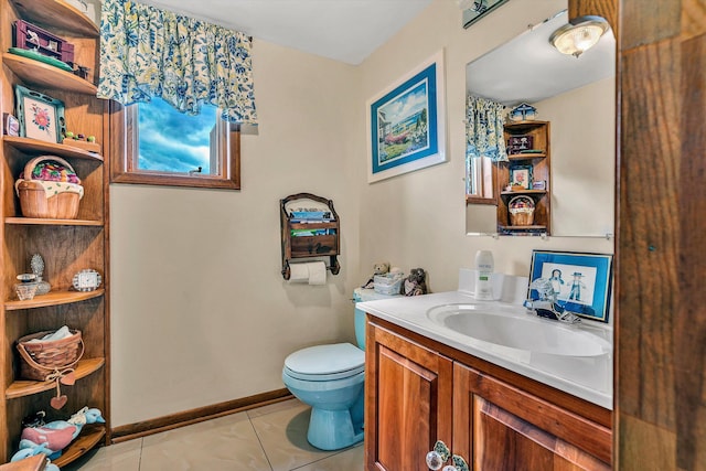 bathroom featuring vanity, tile patterned floors, and toilet