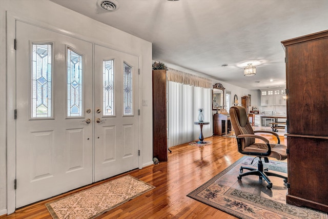 foyer with a wealth of natural light and light hardwood / wood-style floors