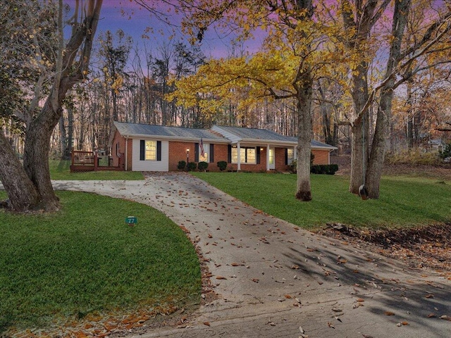 ranch-style home with a lawn