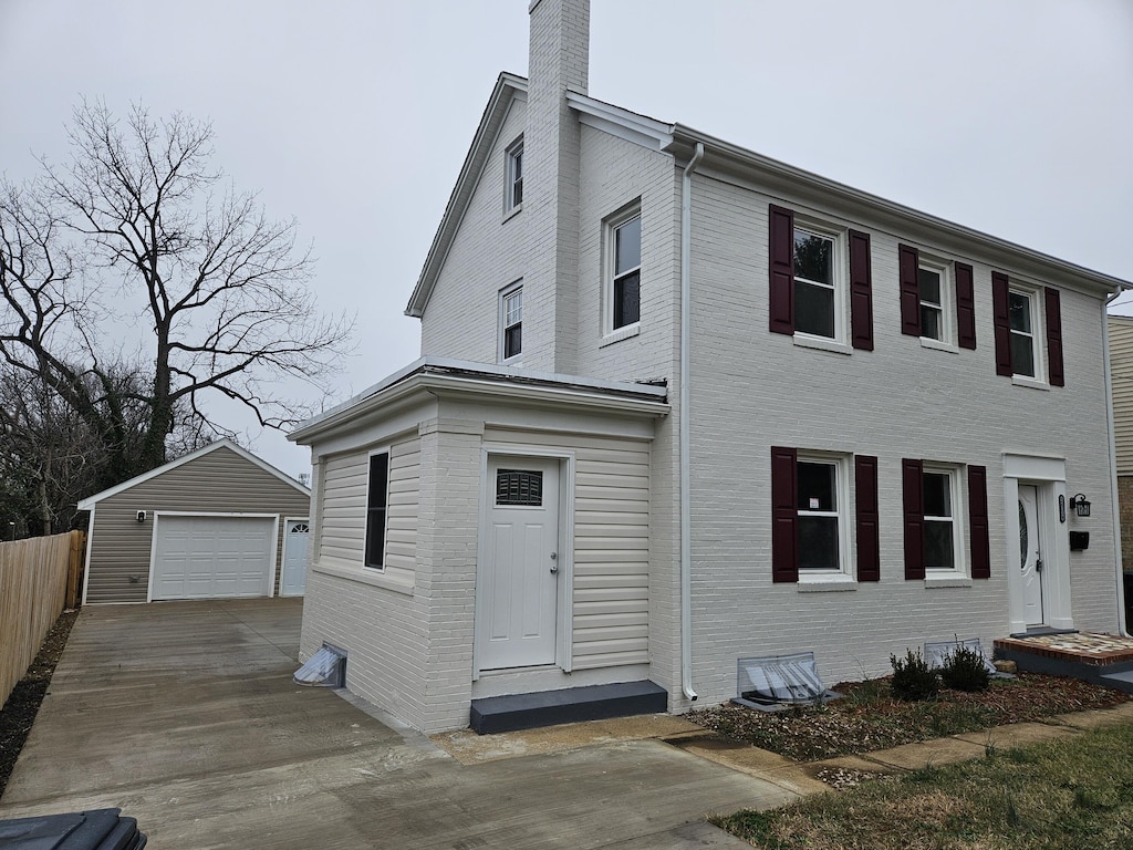 view of front facade featuring an outbuilding and a garage