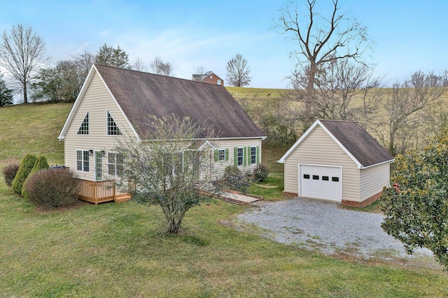 exterior space featuring a front yard, a garage, and an outdoor structure