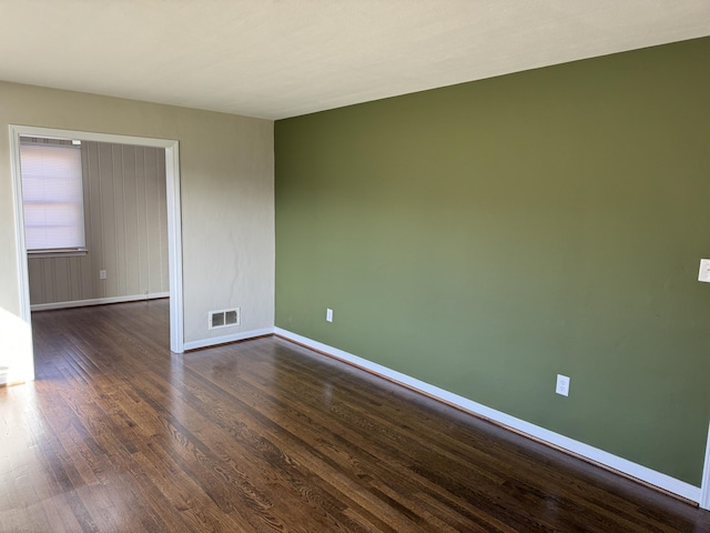 spare room featuring dark hardwood / wood-style floors