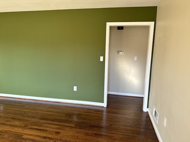 spare room with dark hardwood / wood-style flooring