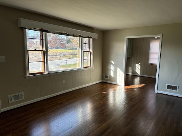 empty room featuring dark hardwood / wood-style flooring