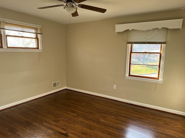 unfurnished room with dark hardwood / wood-style flooring, ceiling fan, and a healthy amount of sunlight