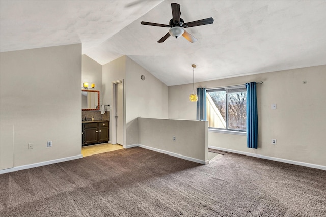 unfurnished room featuring light colored carpet, ceiling fan, and lofted ceiling