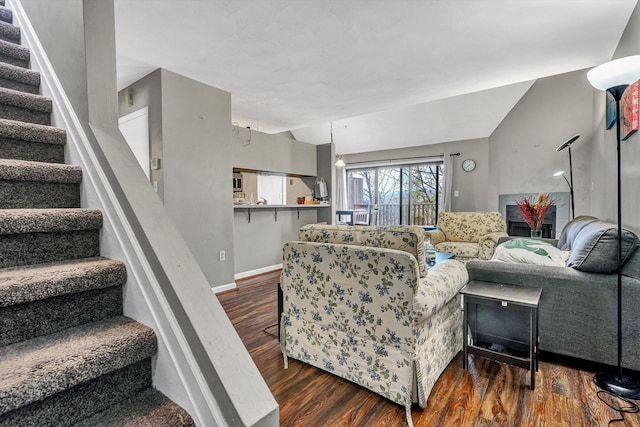 living room with dark hardwood / wood-style flooring and lofted ceiling