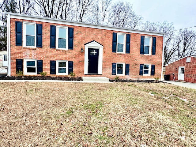 split foyer home with a front lawn