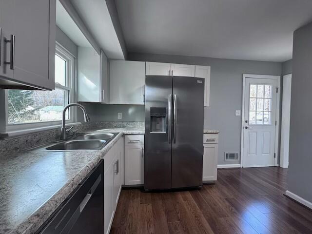 kitchen with white cabinetry, stainless steel fridge with ice dispenser, sink, and a healthy amount of sunlight