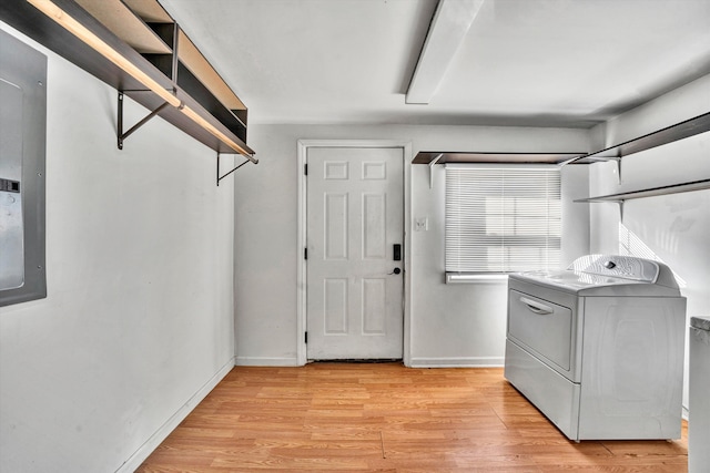 laundry area with washer / clothes dryer and light hardwood / wood-style flooring