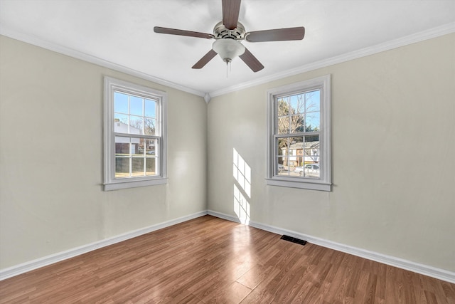 unfurnished room with ceiling fan, plenty of natural light, ornamental molding, and hardwood / wood-style flooring