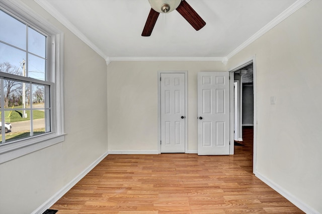 unfurnished bedroom with ceiling fan, crown molding, and light hardwood / wood-style flooring