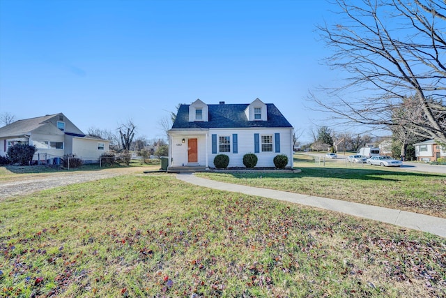 new england style home with a front yard