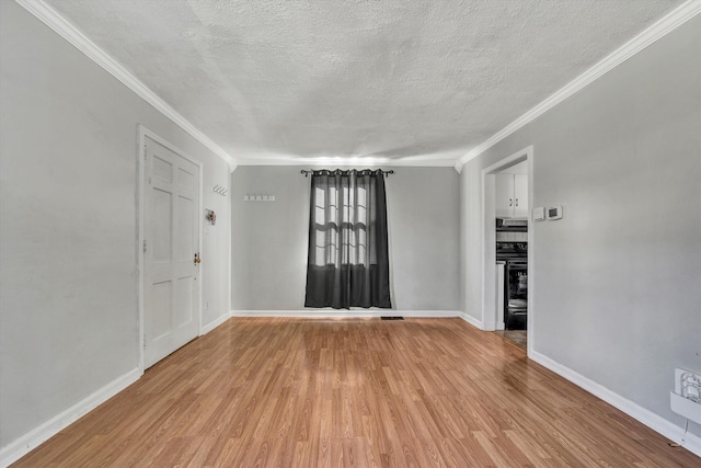 unfurnished room featuring a textured ceiling, light hardwood / wood-style flooring, and ornamental molding