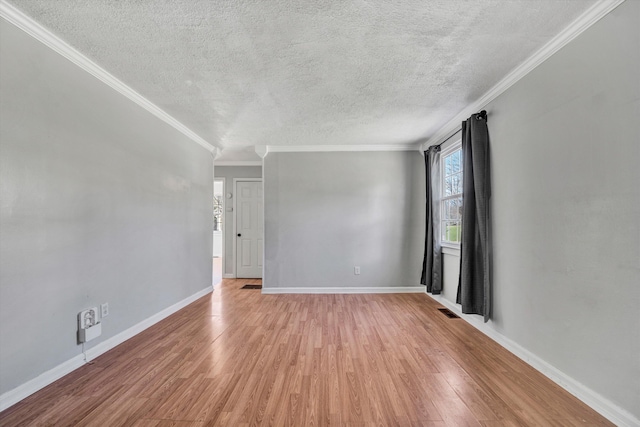 empty room featuring a textured ceiling, crown molding, and light hardwood / wood-style flooring