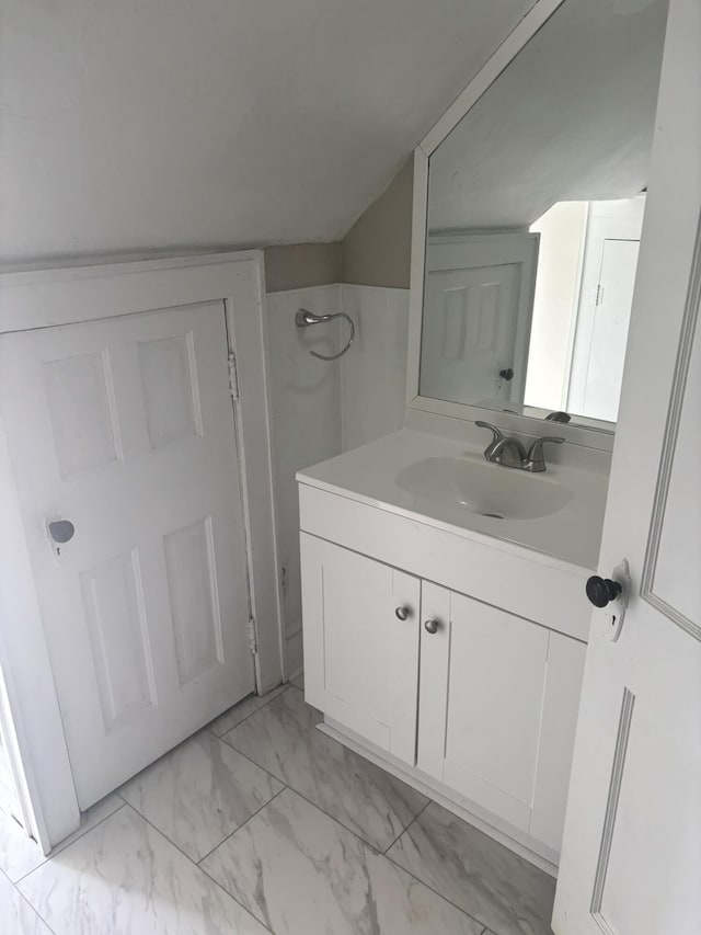 bathroom featuring a shower and vanity