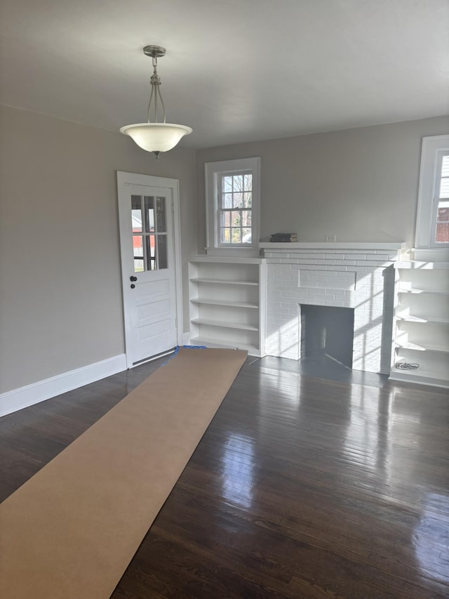 entrance foyer with a fireplace and dark hardwood / wood-style flooring