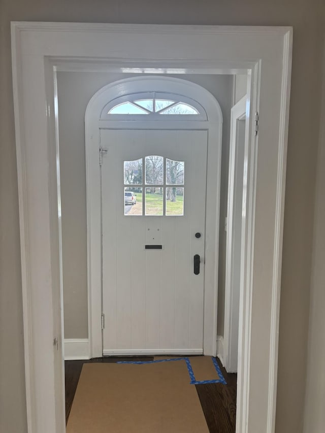 doorway to outside featuring dark wood-type flooring