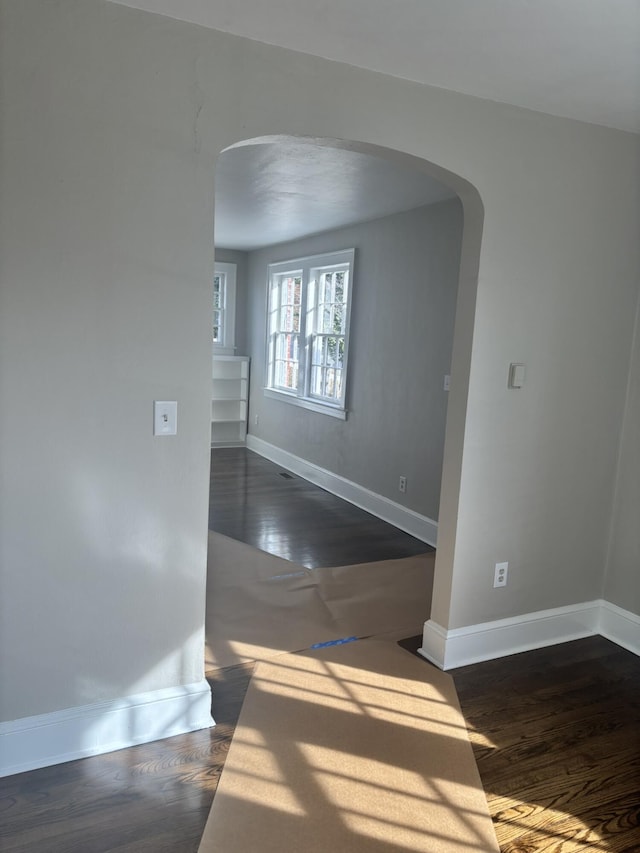 spare room with dark wood-type flooring