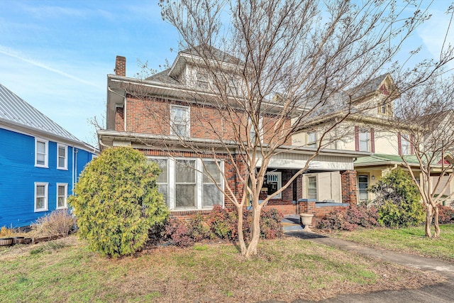 front of property with covered porch and a front lawn