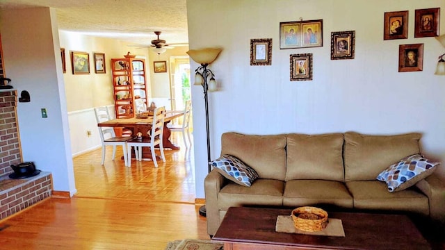 living room with ceiling fan and light hardwood / wood-style floors