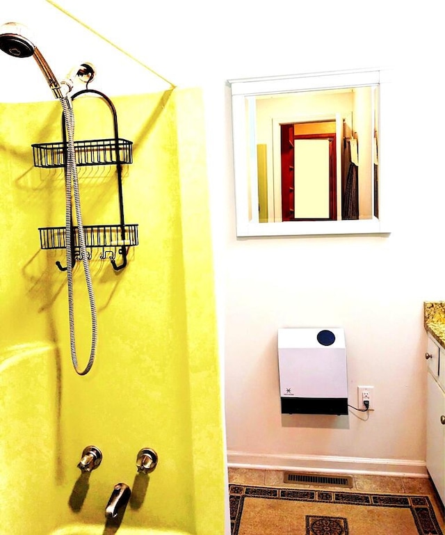 bathroom featuring heating unit and vanity