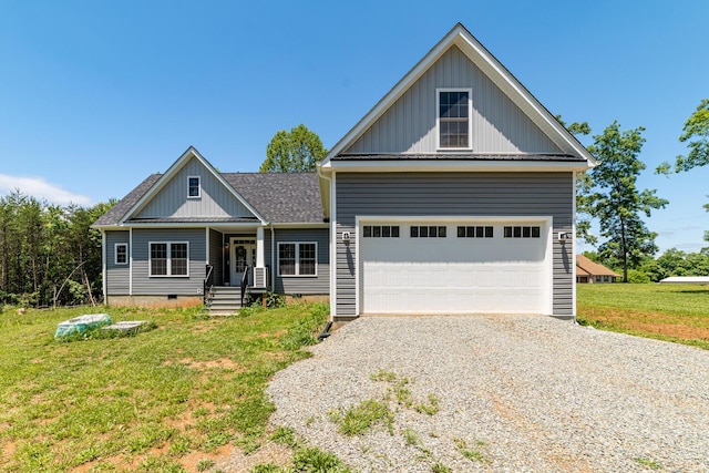 view of front of home featuring a front yard and a garage