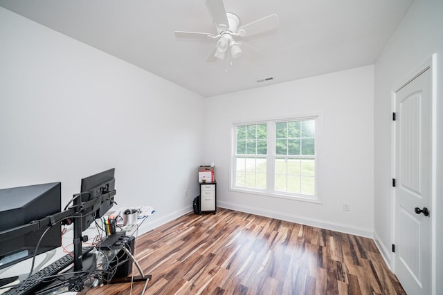 unfurnished office with hardwood / wood-style flooring and ceiling fan