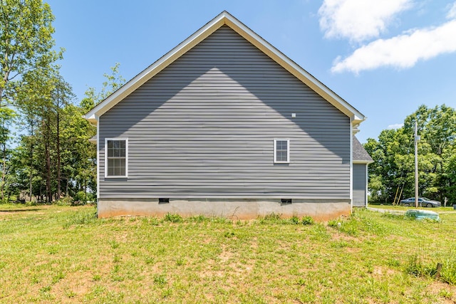 view of side of home featuring a lawn