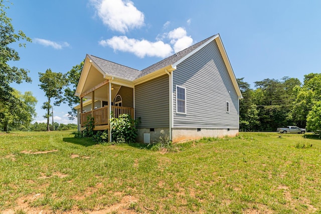 view of side of home with a yard