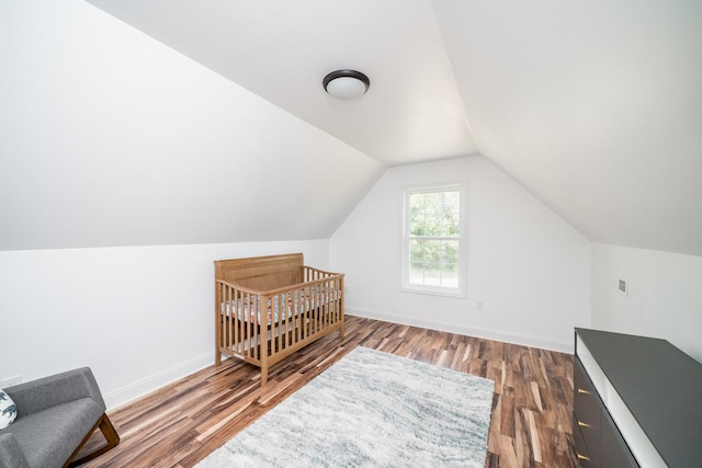 interior space featuring hardwood / wood-style floors and lofted ceiling