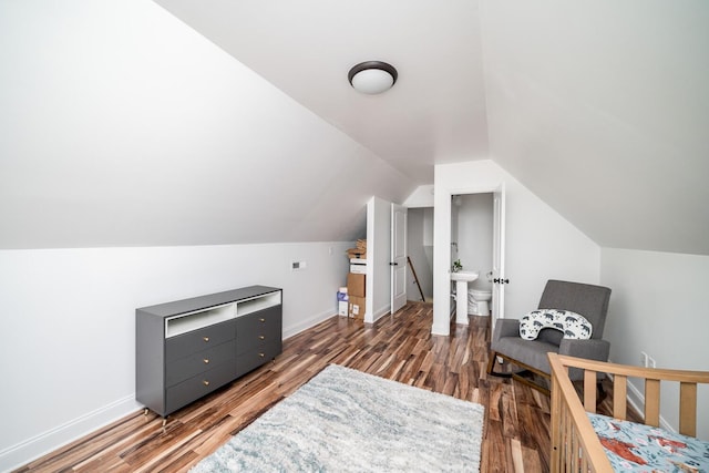 bedroom with dark wood-type flooring and vaulted ceiling