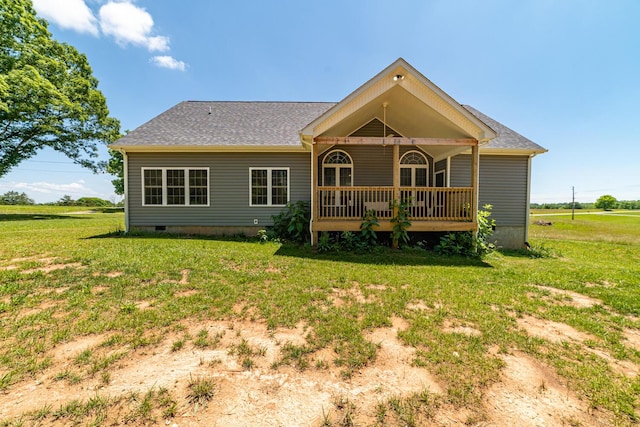 rear view of house featuring a lawn