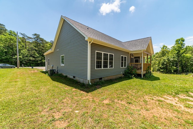 view of side of home with a lawn and central air condition unit