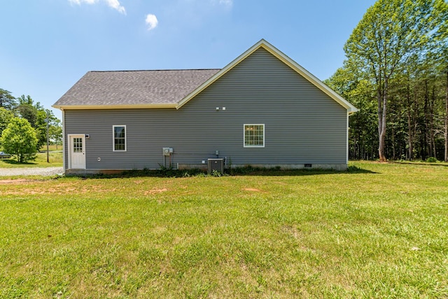 view of home's exterior featuring a lawn and central AC