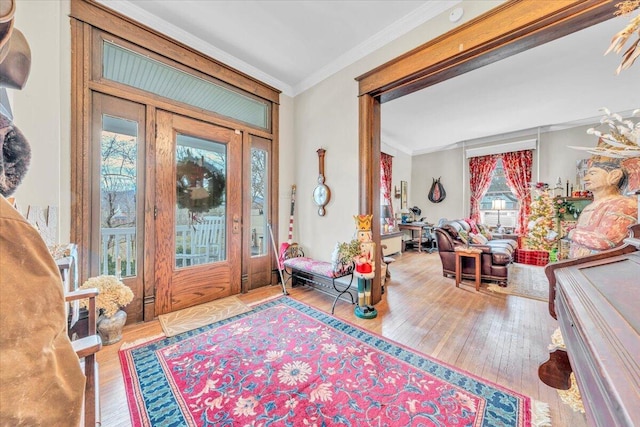 entrance foyer featuring hardwood / wood-style flooring and crown molding