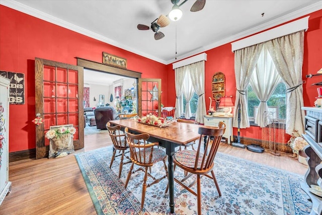 dining room with crown molding, ceiling fan, and light hardwood / wood-style floors