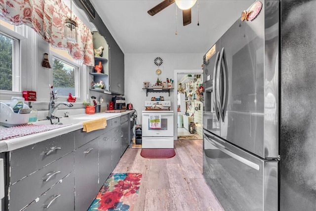 kitchen with stainless steel refrigerator with ice dispenser, ceiling fan, sink, light hardwood / wood-style flooring, and white electric range