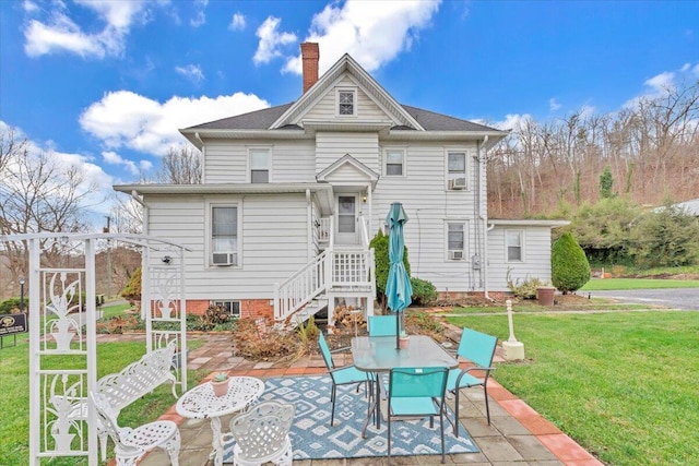 back of house featuring a yard and a patio