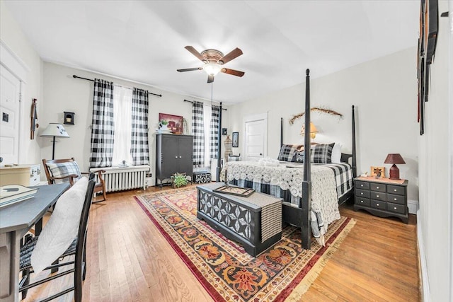 bedroom featuring radiator, ceiling fan, and wood-type flooring