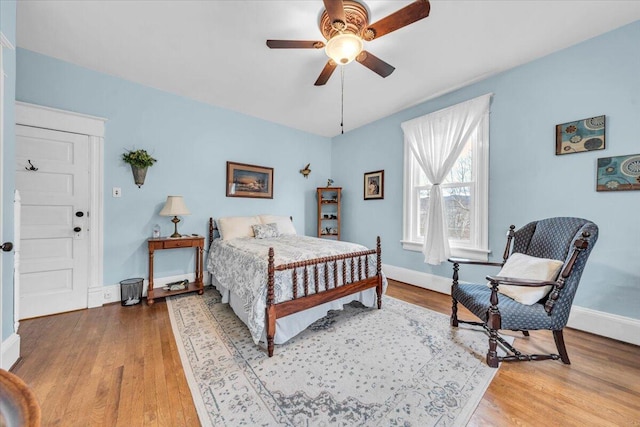 bedroom with hardwood / wood-style floors and ceiling fan