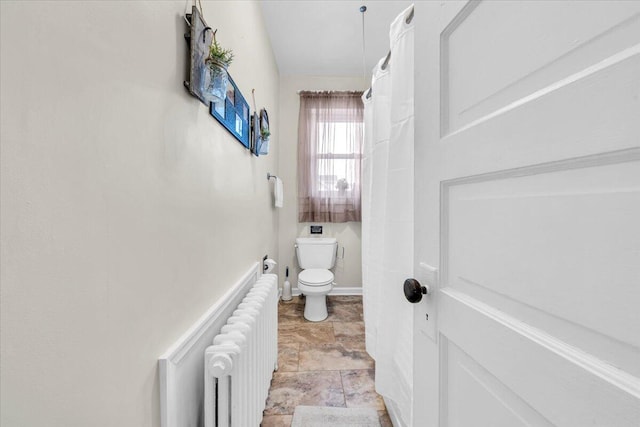 bathroom with toilet and radiator