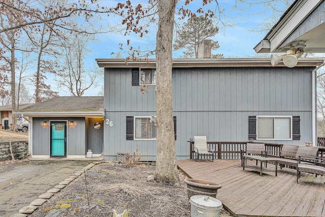 rear view of property with a wooden deck