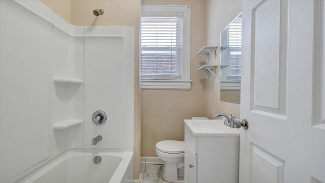 bathroom with washtub / shower combination, vanity, and toilet