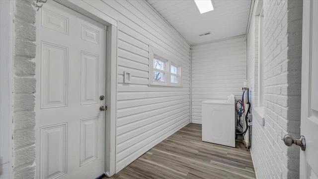 laundry room with laundry area, separate washer and dryer, and light wood finished floors