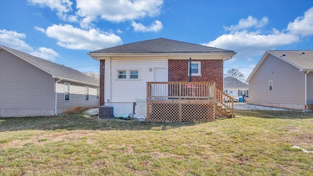 back of house with brick siding, central AC unit, a deck, and a yard