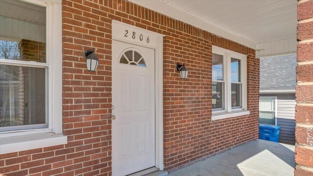 property entrance featuring brick siding