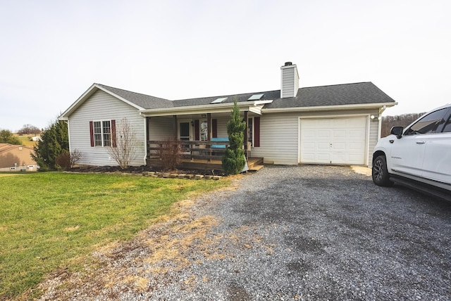 single story home with a front lawn, covered porch, and a garage