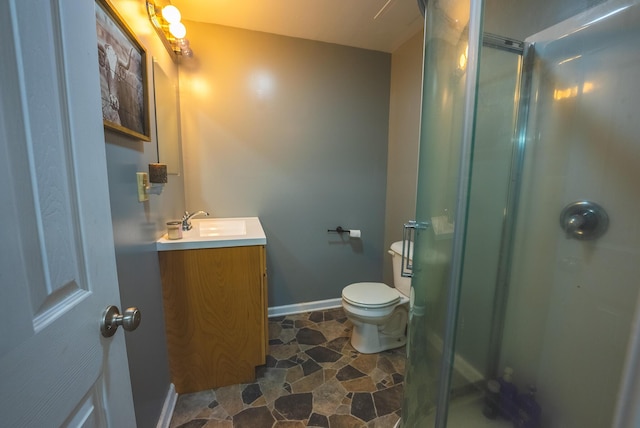 bathroom featuring vanity, an enclosed shower, and toilet