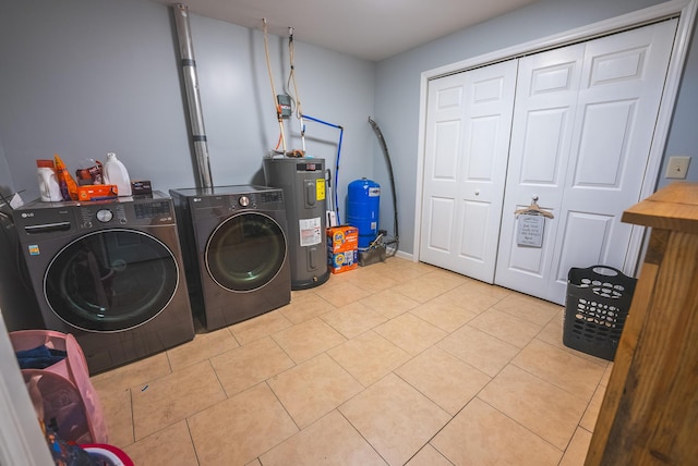 laundry room with light tile patterned floors, electric water heater, and separate washer and dryer